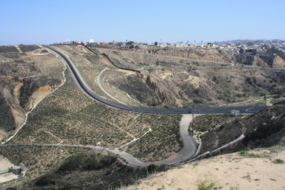 The US-Mexico border zone provides a buffer to help shield the TRNERR from urban expansion on all sides, but the effects of booming development still make their way into the Reserve, in the form of increased debris, sediment and pollution run-off. Above, the border fence curves along the mesas, with Tijuana visible in the background.